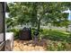 Well-manicured backyard with a grill, mature trees, and lush landscaping, creating a private and serene outdoor oasis at 3612 Se 47Th Ter, Ocala, FL 34480