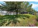 Huge yard with a screen enclosed pool, patio, and large shade trees offers privacy and serenity at 3612 Se 47Th Ter, Ocala, FL 34480