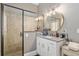 A bathroom featuring a granite countertop vanity and a gorgeous tiled shower with glass doors at 3612 Se 47Th Ter, Ocala, FL 34480