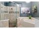 Elegant bathroom features a glass-enclosed shower, soaking tub, and modern fixtures and stylish decor at 3612 Se 47Th Ter, Ocala, FL 34480