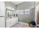 Bathroom featuring a double vanity with white cabinetry, neutral decor, and a shower with marble curtain at 3612 Se 47Th Ter, Ocala, FL 34480