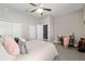 Cozy bedroom featuring a ceiling fan, plush carpet, and walk-in closet at 3612 Se 47Th Ter, Ocala, FL 34480