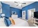 Comfortable bedroom features a plush bed, white dresser, and stylish decor with blue accent walls at 3612 Se 47Th Ter, Ocala, FL 34480