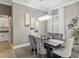 Stylish dining area featuring a modern chandelier, neutral decor, and comfortable seating at 3612 Se 47Th Ter, Ocala, FL 34480
