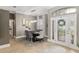 Dining area view from entrance, featuring chandelier lighting and an elegant front door at 3612 Se 47Th Ter, Ocala, FL 34480