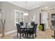 Dining area showcases a glass table with black chairs, wine rack, beverage cooler, and shuttered windows at 3612 Se 47Th Ter, Ocala, FL 34480