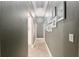 A long hallway decorated with framed black and white pictures and neutrally painted walls at 3612 Se 47Th Ter, Ocala, FL 34480