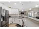 Modern kitchen with stainless steel appliances, granite countertops, and a breakfast bar overlooking the living area at 3612 Se 47Th Ter, Ocala, FL 34480