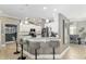 Spacious kitchen featuring white cabinetry, stainless appliances, and breakfast bar with pendant lighting at 3612 Se 47Th Ter, Ocala, FL 34480