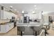 Bright open kitchen with stainless steel appliances, white cabinets, and a breakfast bar at 3612 Se 47Th Ter, Ocala, FL 34480
