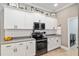 Kitchen featuring white cabinets, gray countertops, and stainless steel appliances at 3612 Se 47Th Ter, Ocala, FL 34480