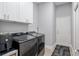 A fully equipped laundry room with modern appliances and storage at 3612 Se 47Th Ter, Ocala, FL 34480