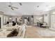 Spacious living area with white couches, tile floors, and open floor plan to dining and kitchen areas at 3612 Se 47Th Ter, Ocala, FL 34480