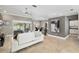 Living area with tile floors, sectional sofa, recessed lights, sliding doors to patio, and view of the kitchen at 3612 Se 47Th Ter, Ocala, FL 34480