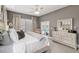 Large main bedroom with french doors to the pool area, dresser, ceiling fan, and neutral decor at 3612 Se 47Th Ter, Ocala, FL 34480