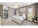 Beautiful main bedroom with carpet, ceiling fan, side tables, artwork, and luxury decor at 3612 Se 47Th Ter, Ocala, FL 34480