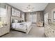 Spacious main bedroom with a ceiling fan, bedside tables, dresser, and natural light at 3612 Se 47Th Ter, Ocala, FL 34480