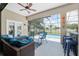 Relaxing screened patio with comfortable seating, ceiling fan, and direct access to the pool area for outdoor enjoyment at 3612 Se 47Th Ter, Ocala, FL 34480
