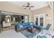 Charming screened patio with plush seating, ceiling fan, and direct access to both the pool and the home's interior at 3612 Se 47Th Ter, Ocala, FL 34480