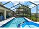 Relaxing screened-in pool and spa with a spacious patio area for outdoor dining and lounging in a private setting at 3612 Se 47Th Ter, Ocala, FL 34480