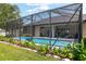 Well-maintained screened-in pool with a covered patio and manicured landscaping, creating a serene outdoor retreat at 3612 Se 47Th Ter, Ocala, FL 34480