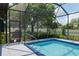 Serene screened pool with spa, mature trees, and lush landscaping offers a private and peaceful outdoor setting at 3612 Se 47Th Ter, Ocala, FL 34480