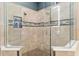 Spacious glass shower features pebble floor, built-in niche, and sleek tile in modern bathroom at 3612 Se 47Th Ter, Ocala, FL 34480