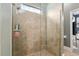 The bathroom features a walk-in shower with gorgeous neutral tiling and a glass door at 3612 Se 47Th Ter, Ocala, FL 34480