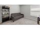 Neutral bedroom with a gray futon, shelving, and carpeted floors for a cozy atmosphere at 4909 Se 89Th St, Ocala, FL 34480