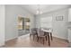 Bright dining area features a modern light fixture, sliding glass doors to the backyard and seating for four at 4909 Se 89Th St, Ocala, FL 34480