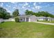 Single-story home featuring a well-manicured lawn and inviting curb appeal at 4909 Se 89Th St, Ocala, FL 34480