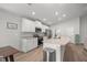 Beautiful white kitchen features granite countertops, stainless steel appliances, and a breakfast bar at 4909 Se 89Th St, Ocala, FL 34480