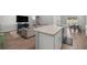 Open-concept living room featuring hardwood floors, a comfortable sofa, and a modern kitchen bar at 4909 Se 89Th St, Ocala, FL 34480