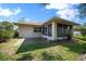 The home's backyard features a screened-in porch and a quaint patio, ideal for outdoor entertaining at 4992 Nw 31St St, Ocala, FL 34482
