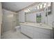 Bathroom featuring double sinks, neutral tile, and a glass enclosed shower at 4992 Nw 31St St, Ocala, FL 34482