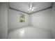 Sunlit bedroom with tiled floors and a window overlooking the backyard at 4992 Nw 31St St, Ocala, FL 34482