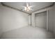 Bright bedroom with tiled floor, ceiling fan, and closet for storage at 4992 Nw 31St St, Ocala, FL 34482