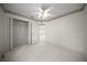 Bright bedroom with tiled floor, ceiling fan, and closet for storage at 4992 Nw 31St St, Ocala, FL 34482