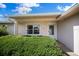 Close up of the front entrance with manicured landscaping and a window view at 4992 Nw 31St St, Ocala, FL 34482