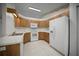 Traditional kitchen featuring wood cabinets and white appliances at 4992 Nw 31St St, Ocala, FL 34482