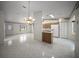 Open concept living room with tiled floors, kitchen and breakfast bar at 4992 Nw 31St St, Ocala, FL 34482