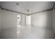 Neutral-toned bedroom with tile floors and view into the ensuite bathroom at 4992 Nw 31St St, Ocala, FL 34482