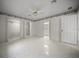Bright bedroom with tile floors, ceiling fan, and closet storage at 4992 Nw 31St St, Ocala, FL 34482