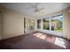Enclosed sunroom with carpet flooring and lots of natural light at 4992 Nw 31St St, Ocala, FL 34482