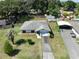 Aerial view showcasing the property's layout with a well-maintained lawn, driveway, and surrounding greenery at 5060 Ne 4Th St, Ocala, FL 34470