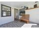 Relaxing back porch with stylish wood-look flooring and a peaceful seating area at 5060 Ne 4Th St, Ocala, FL 34470