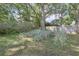 The fenced backyard features lush greenery and mature trees, creating a private outdoor space at 5060 Ne 4Th St, Ocala, FL 34470