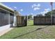 The spacious backyard with a wooden shower offers a relaxing outdoor experience at 5060 Ne 4Th St, Ocala, FL 34470