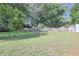Spacious backyard with a fire pit, surrounded by lush greenery and mature trees at 5060 Ne 4Th St, Ocala, FL 34470