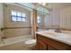 The bathroom features tiled walls, a bathtub, and a large vanity mirror above the sink at 5060 Ne 4Th St, Ocala, FL 34470